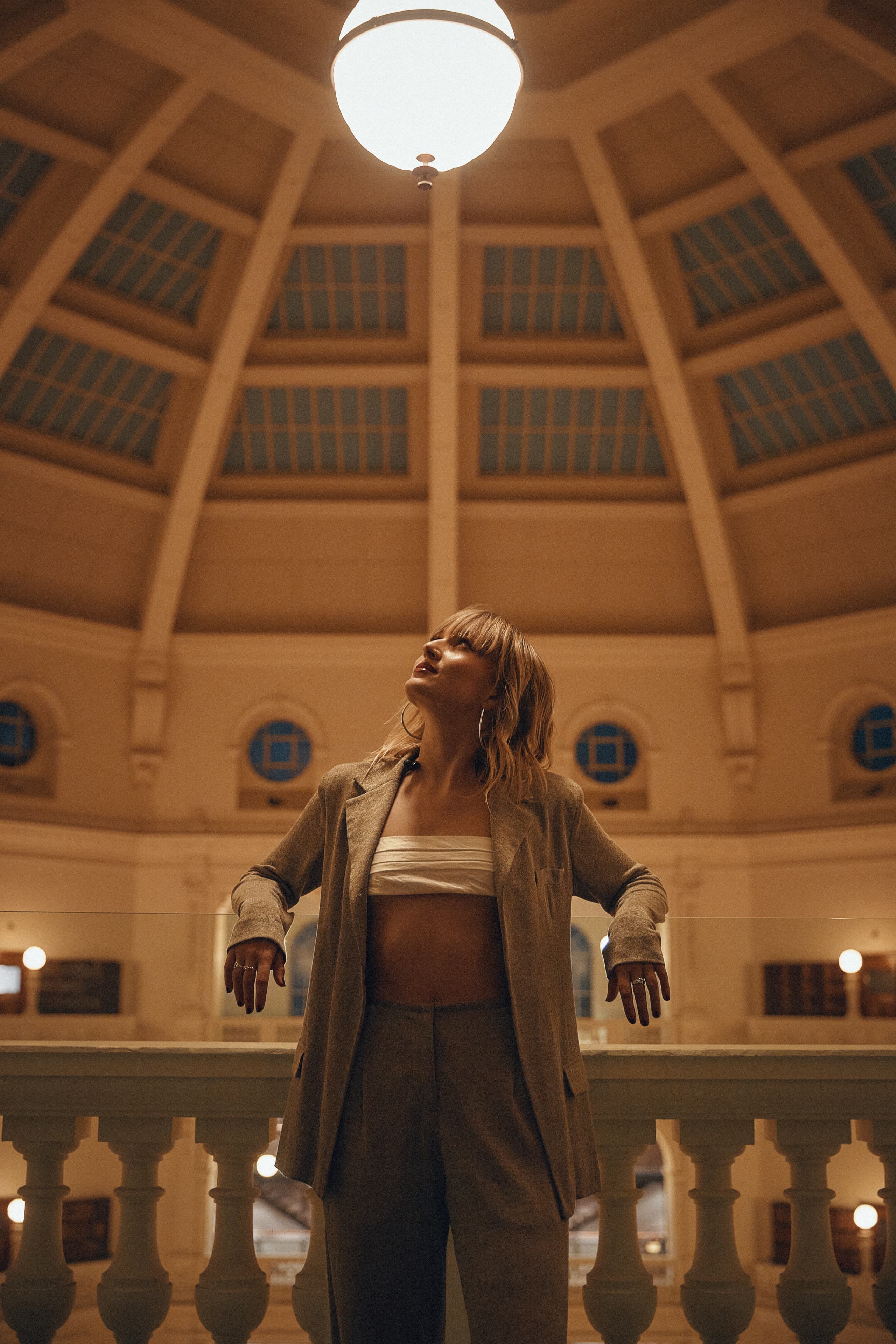 Gretta Ray looking up beneath the dome of the State Library of Victoria during an Amazon Music live session
