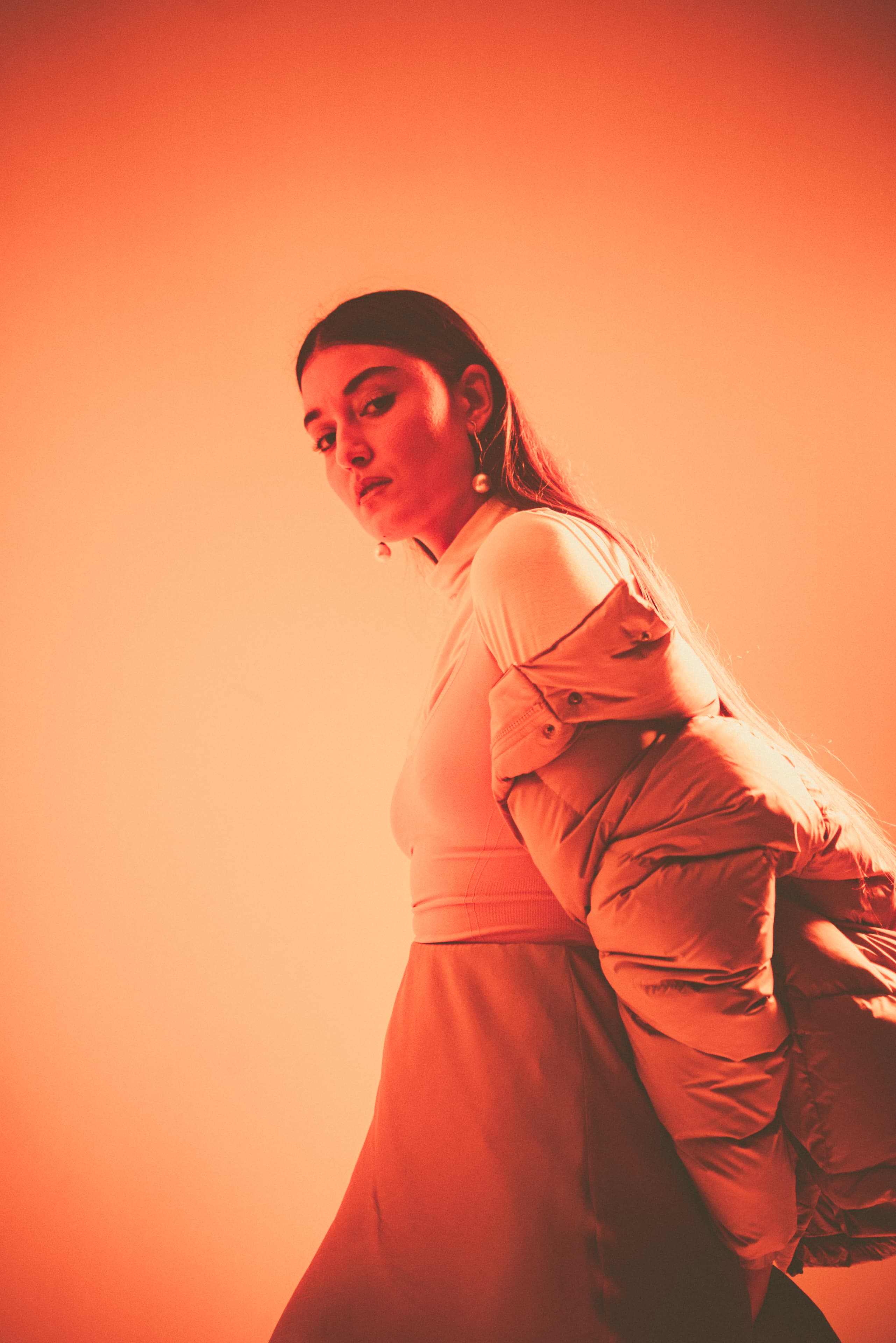 Behind-the-scenes production photography of woman in orange outfit — fashion and lifestyle video production by Mude creative agency Sydney