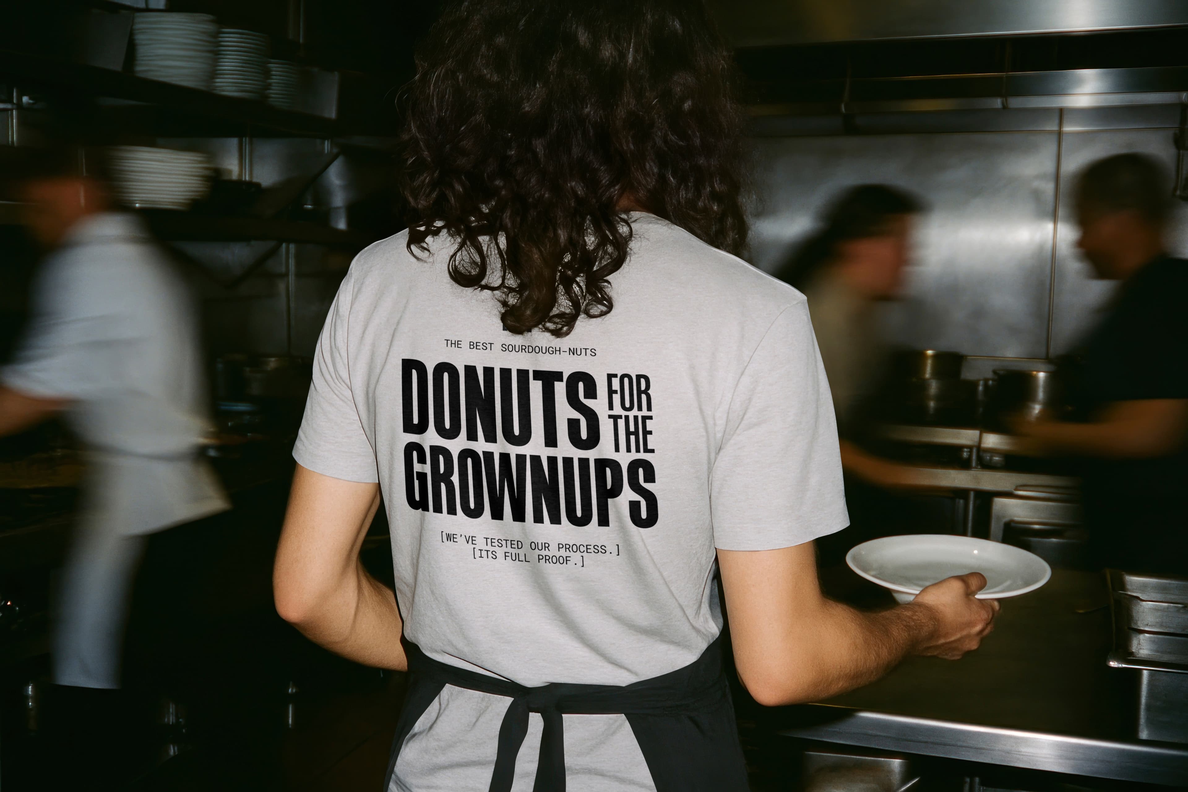 Branded t-shirt mockup for Full Proof sourdough doughnuts — hospitality merchandise and brand collateral by Mude